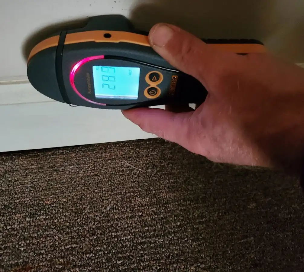 Moisture detection at baseboard during Storm Damage Restoration in Florence
